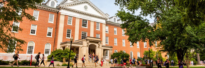 Students pass by Fell Hall.